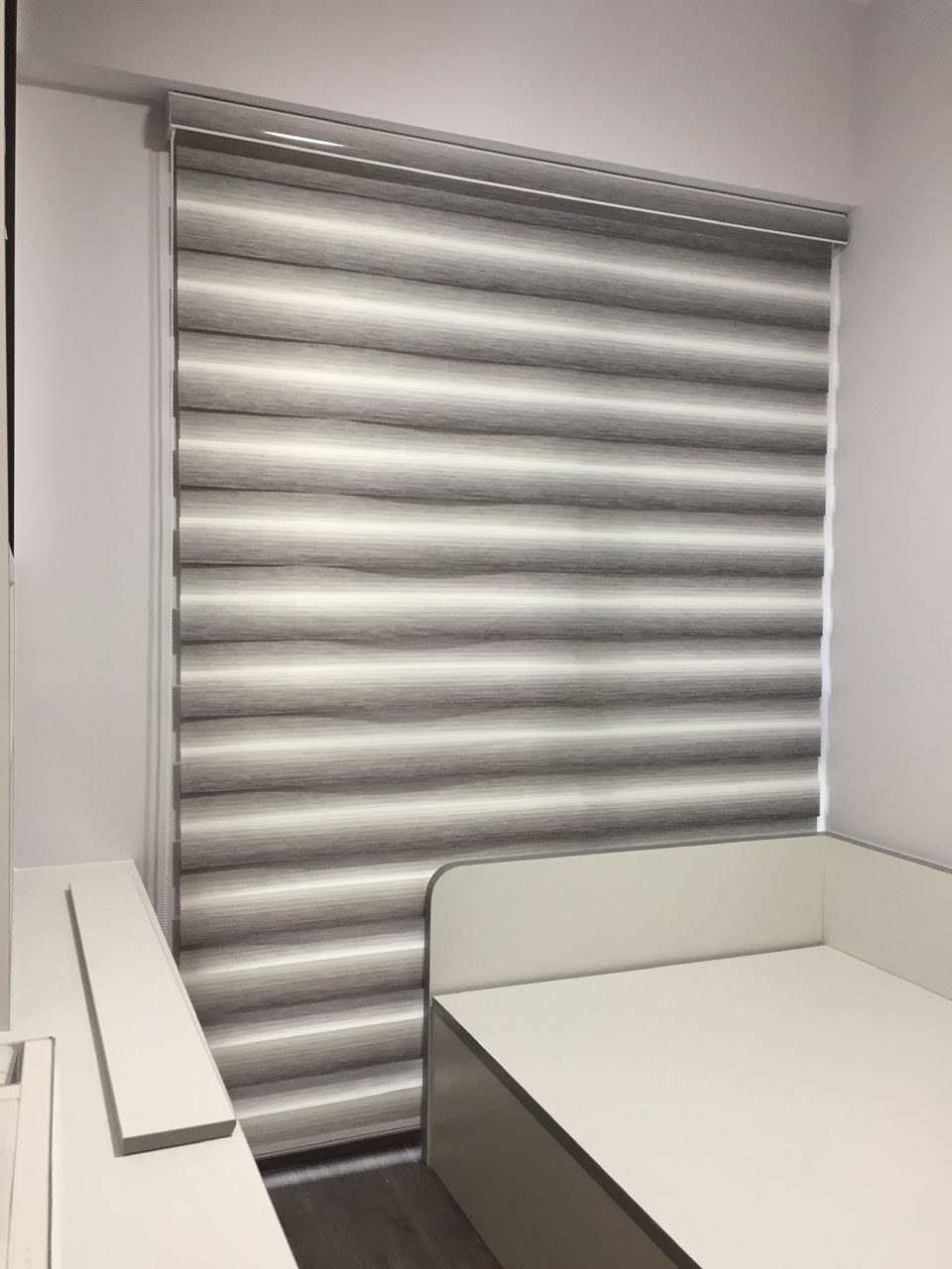 Combi blind offset to a private shade in a Singapore bedroom