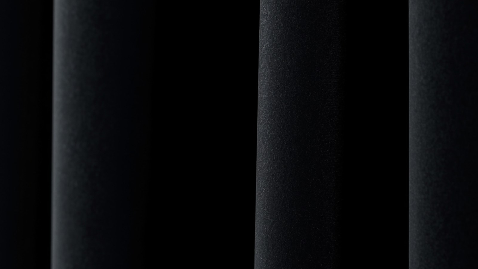 Blackout night curtains blocking near-total light for a fully dark bedroom
