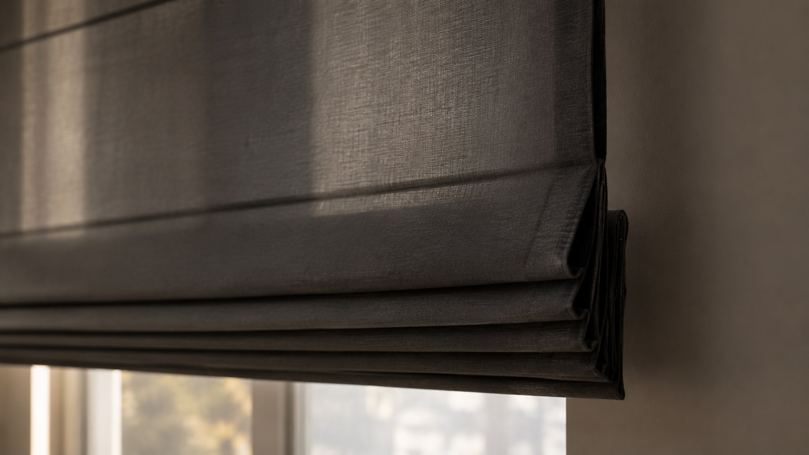 Close-up of a Roman blind showing its soft, even horizontal folds as the fabric stacks while lifting