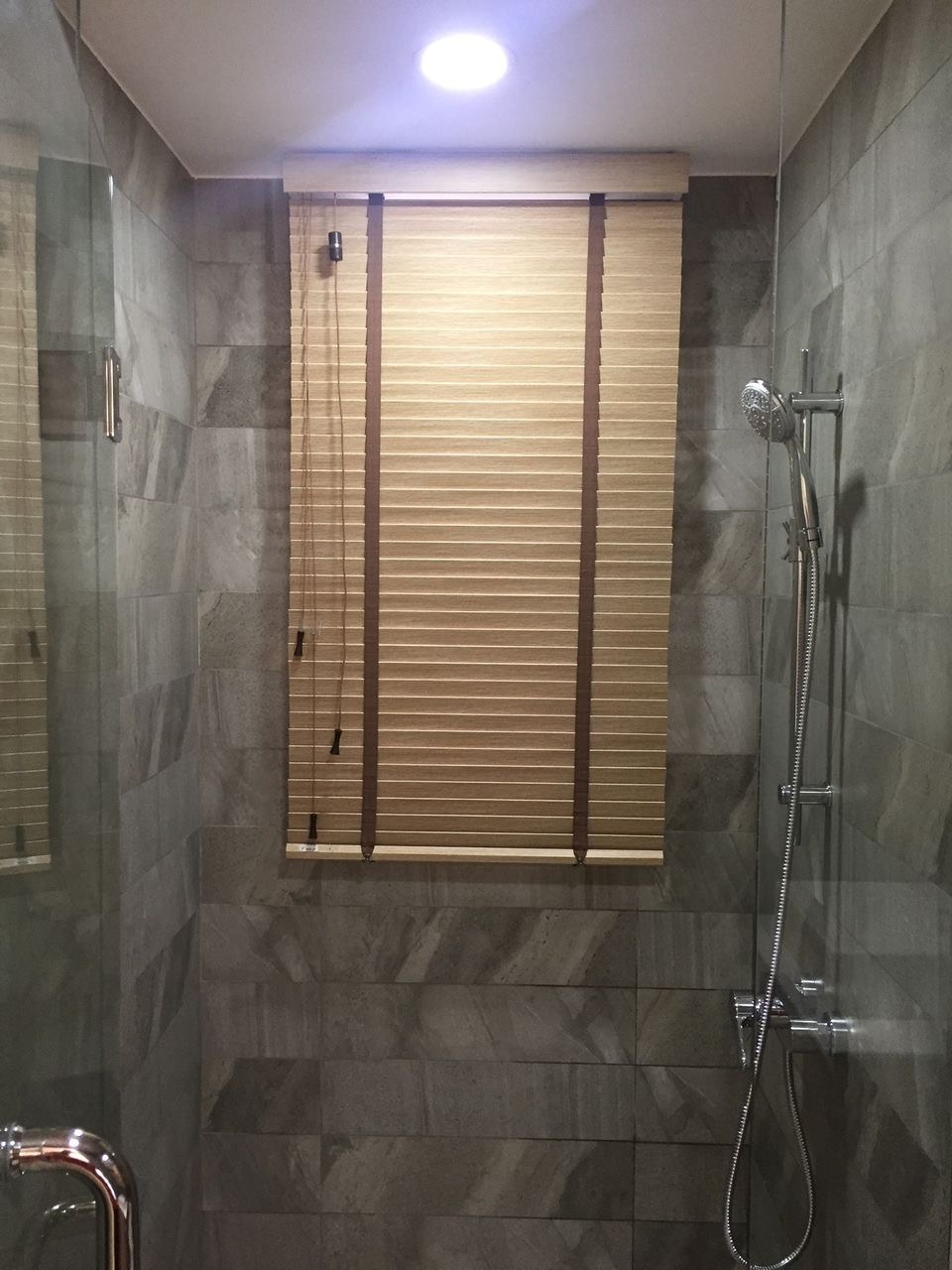 Wooden Venetian blind dressing a window in a Singapore home